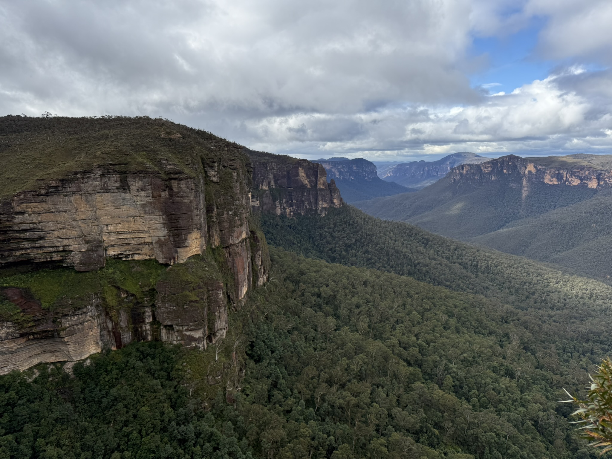 Picturesque view of the Blue Mountains and valley floor below during our family travel adventure