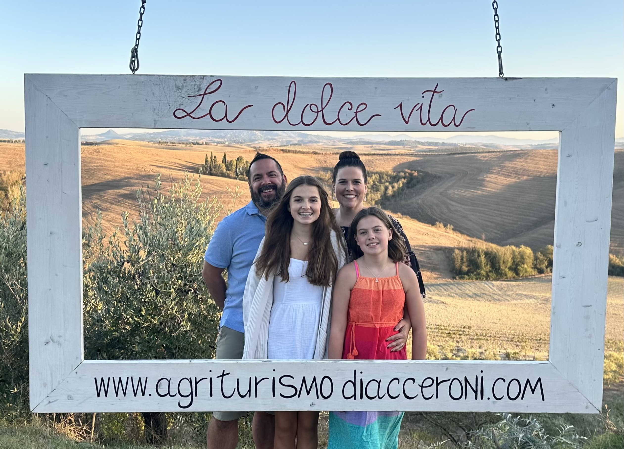 Family picture in a large frame, Tuscan hills in the background